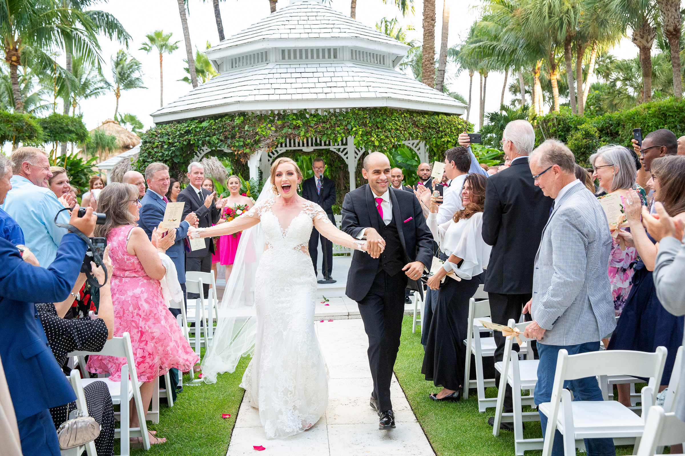 A couple walk down the aisle after their wedding ceremony at the Palms Hotel in Miami Beach.