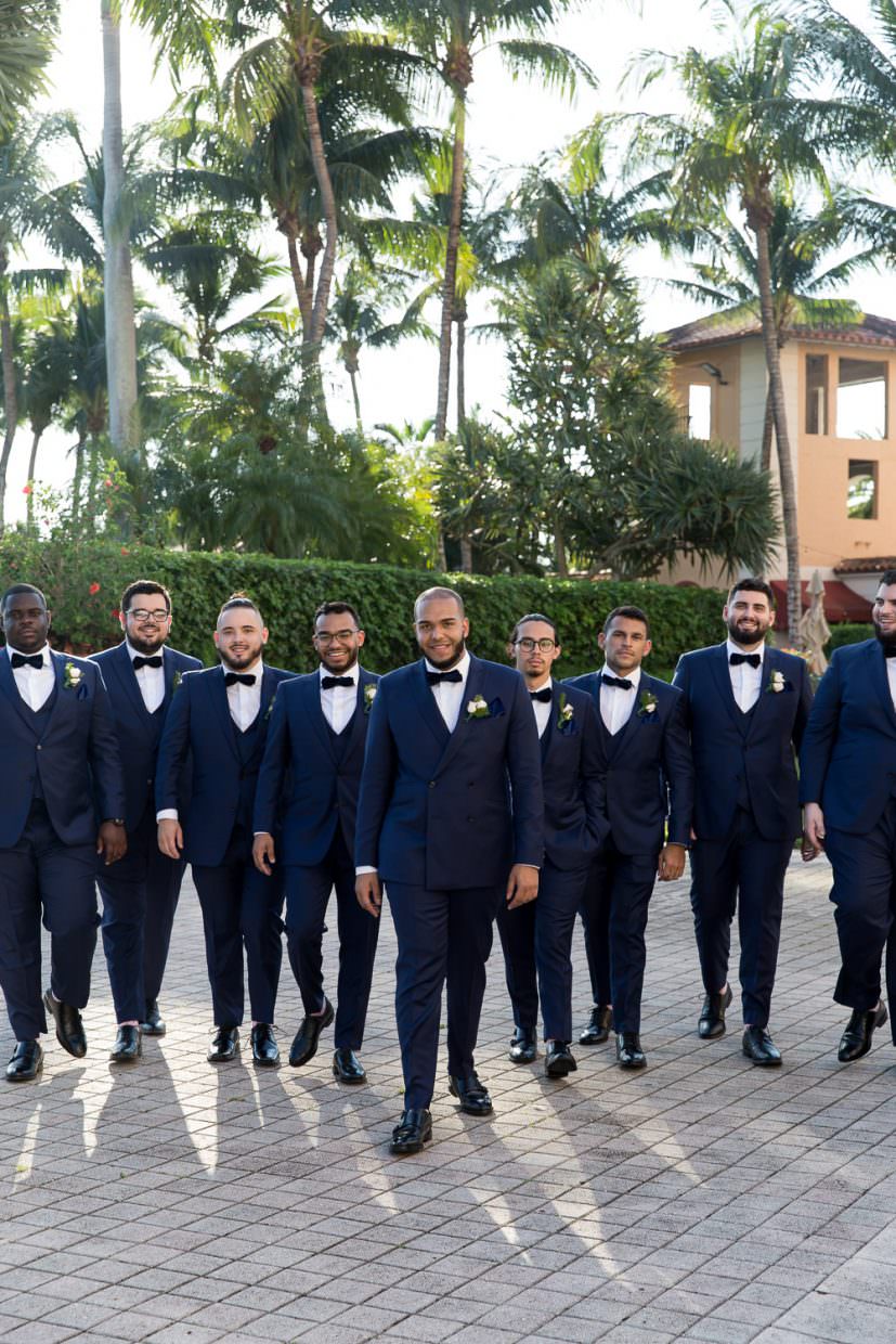 Groomsmen pose for a photo at the Biltmore hotel during a wedding.